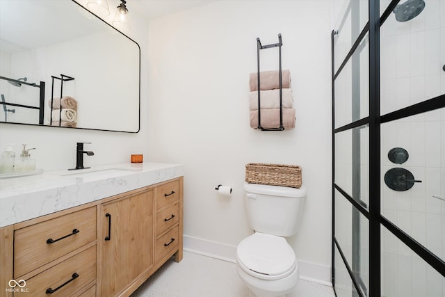 611 N Park Ave Unit 108, Indianapolis, IN 46204 - bathroom featuring vanity, a tile shower, baseboards, and toilet