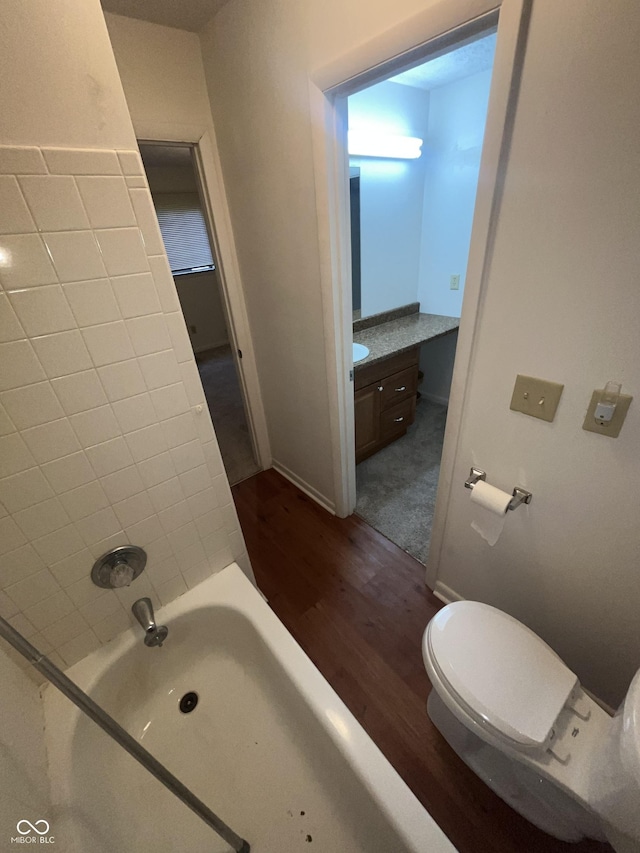 5711 Bradston Way, Indianapolis, IN 46237 - full bathroom with wood finished floors, a bath, vanity, toilet, and baseboards