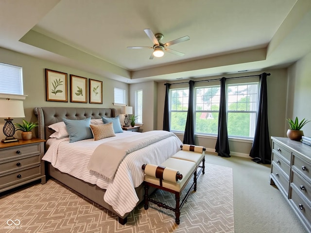 17399 Dovehouse Ln, Westfield, IN 46074 - bedroom featuring a tray ceiling, light colored carpet, baseboards, and ceiling fan