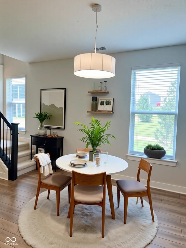 17399 Dovehouse Ln, Westfield, IN 46074 - dining area with light wood finished floors, stairs, healthy amount of natural light, and baseboards