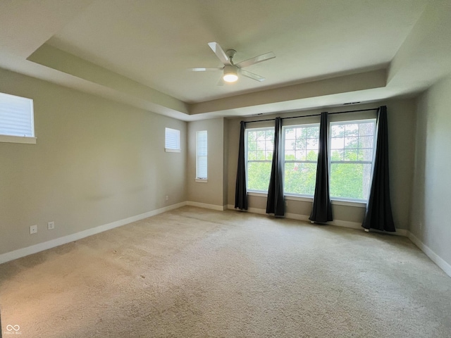 17399 Dovehouse Ln, Westfield, IN 46074 - unfurnished room featuring a raised ceiling, ceiling fan, light colored carpet, and baseboards