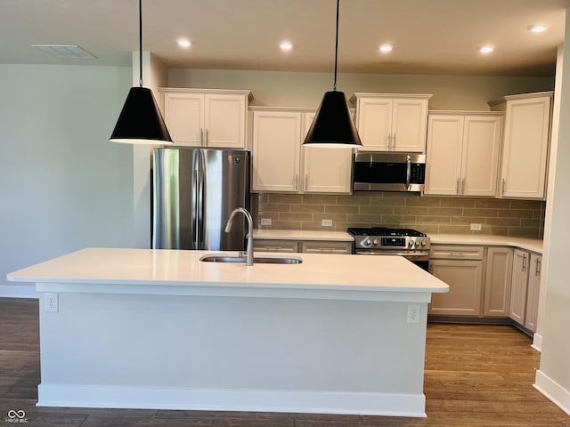 17399 Dovehouse Ln, Westfield, IN 46074 - kitchen featuring appliances with stainless steel finishes, a sink, tasteful backsplash, wood finished floors, and recessed lighting