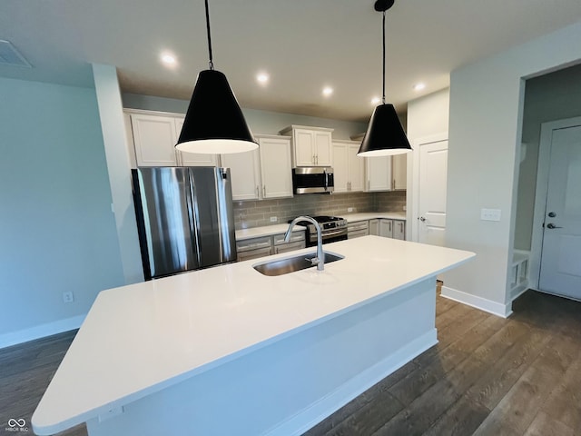 17399 Dovehouse Ln, Westfield, IN 46074 - kitchen featuring appliances with stainless steel finishes, a sink, backsplash, dark wood-style flooring, and recessed lighting