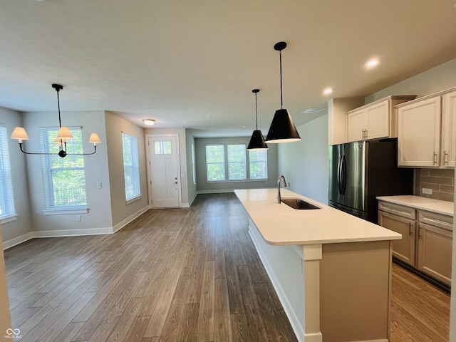17399 Dovehouse Ln, Westfield, IN 46074 - kitchen with a sink, wood finished floors, freestanding refrigerator, light countertops, and recessed lighting