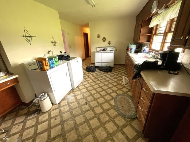 851 E Franklin St, Spencer, IN 47460 - kitchen with washer and dryer, light floors, light countertops, and dark brown cabinets