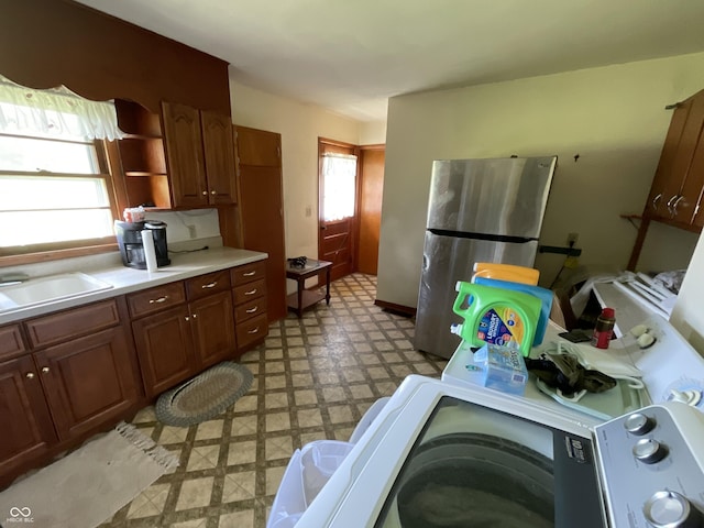 851 E Franklin St, Spencer, IN 47460 - kitchen featuring freestanding refrigerator, light floors, light countertops, open shelves, and washer / dryer