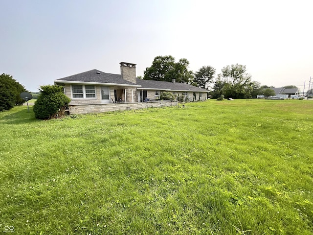 851 E Franklin St, Spencer, IN 47460 - rear view of house with a chimney, a lawn, and stone siding