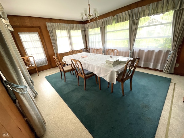 851 E Franklin St, Spencer, IN 47460 - dining space with a chandelier, tile patterned floors, and wood walls