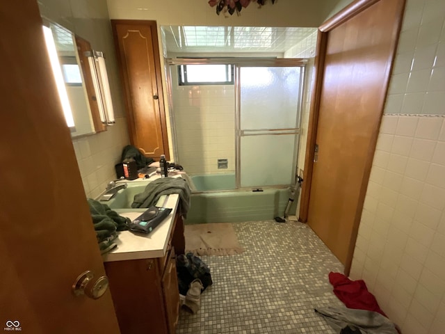 851 E Franklin St, Spencer, IN 47460 - bathroom with tile walls, vanity, combined bath / shower with glass door, and tile patterned floors