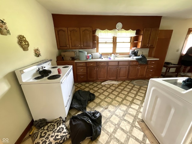 851 E Franklin St, Spencer, IN 47460 - kitchen featuring white electric stove, washer / clothes dryer, light floors, and light countertops