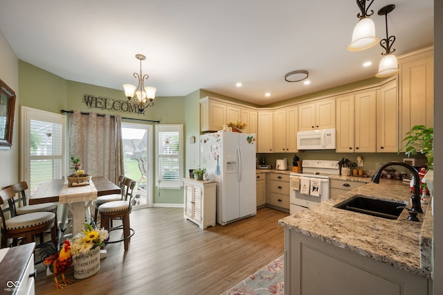 5576 W Glenview Dr, Mccordsville, IN 46055 - kitchen featuring white appliances, a sink, light wood-style floors, light stone counters, and a chandelier