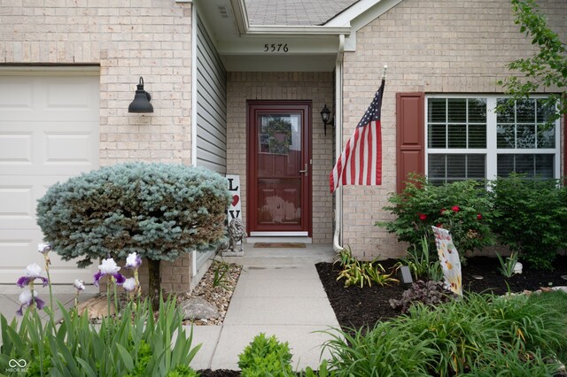 5576 W Glenview Dr, Mccordsville, IN 46055 - property entrance with a garage and brick siding