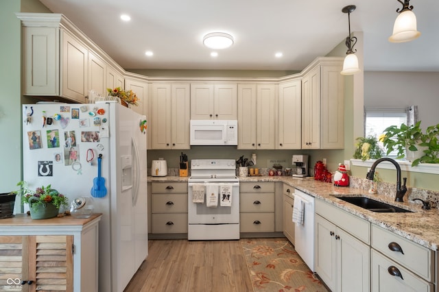 5576 W Glenview Dr, Mccordsville, IN 46055 - kitchen featuring white appliances, a sink, light wood finished floors, hanging light fixtures, and light stone countertops