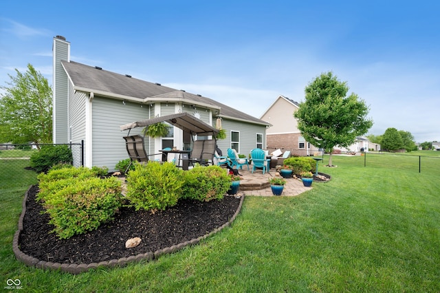 5576 W Glenview Dr, Mccordsville, IN 46055 - back of property with a chimney and a patio