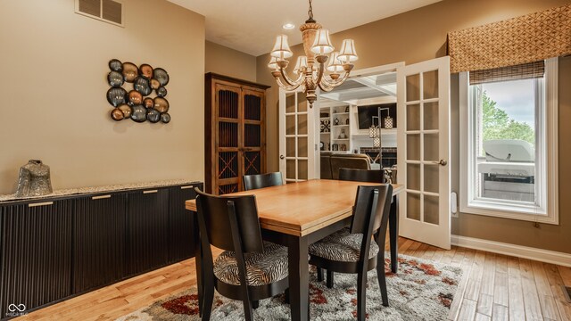 12539 Pebblepointe Pass, Carmel, IN 46033 - dining space with a chandelier, french doors, light wood-style flooring, and baseboards
