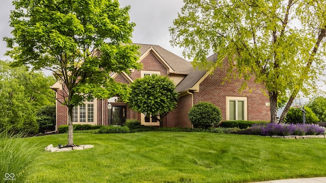 12539 Pebblepointe Pass, Carmel, IN 46033 - view of front of property with brick siding, a front lawn, and a shingled roof