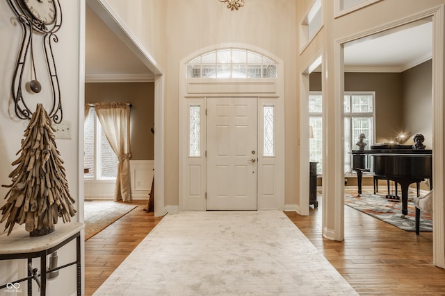 12539 Pebblepointe Pass, Carmel, IN 46033 - foyer entrance featuring wood-type flooring, ornamental molding, and wainscoting
