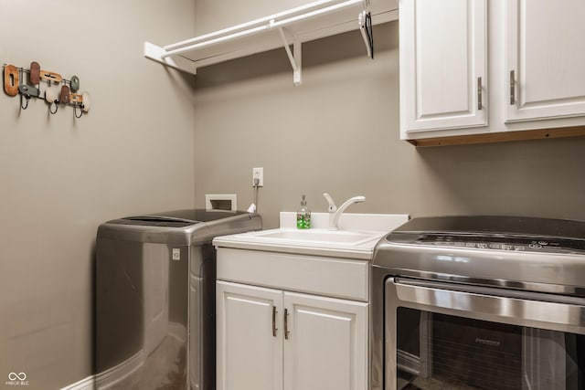 12539 Pebblepointe Pass, Carmel, IN 46033 - laundry room with cabinet space and washing machine and clothes dryer