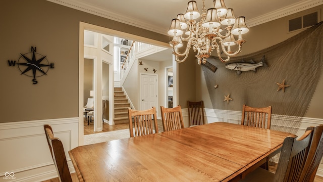 12539 Pebblepointe Pass, Carmel, IN 46033 - dining room featuring a chandelier, wainscoting, stairway, and crown molding