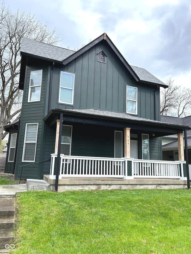 909 N Temple Ave, Indianapolis, IN 46201 - view of front of home with covered porch, board and batten siding, a front lawn, and roof with shingles