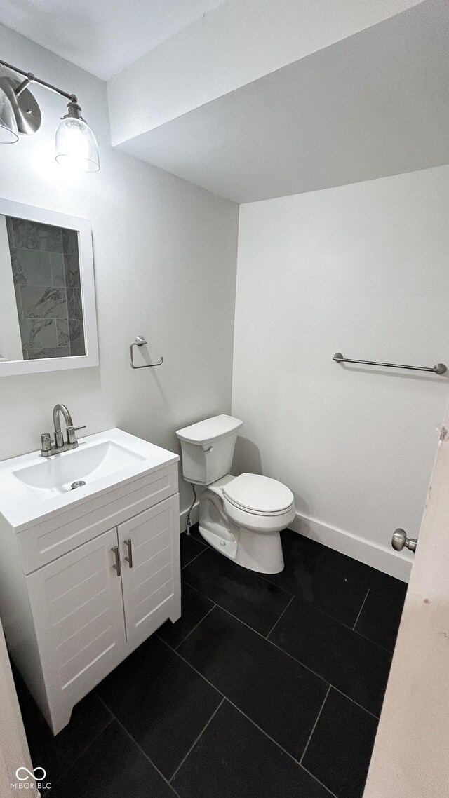 909 N Temple Ave, Indianapolis, IN 46201 - bathroom with toilet, vanity, and tile patterned flooring