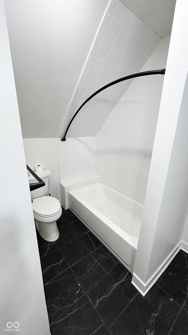 909 N Temple Ave, Indianapolis, IN 46201 - bathroom featuring toilet, marble look tile flooring, shower / bath combination, and baseboards