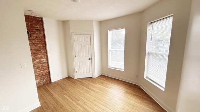 909 N Temple Ave, Indianapolis, IN 46201 - spare room with light wood-type flooring, healthy amount of natural light, and baseboards