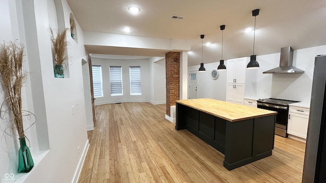 909 N Temple Ave, Indianapolis, IN 46201 - kitchen featuring wall chimney range hood, electric range, wood counters, light wood-style flooring, and recessed lighting