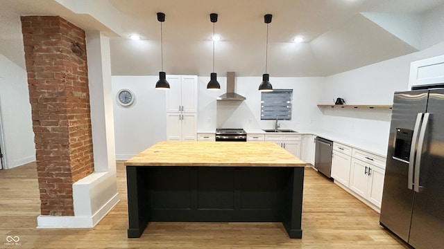 909 N Temple Ave, Indianapolis, IN 46201 - kitchen with appliances with stainless steel finishes, wall chimney range hood, wood counters, white cabinets, and a center island