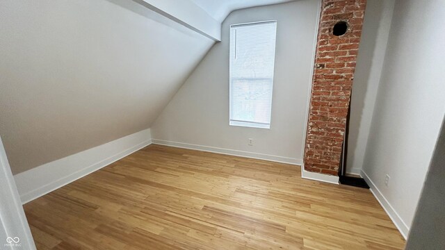 909 N Temple Ave, Indianapolis, IN 46201 - additional living space with light wood finished floors, vaulted ceiling, and baseboards