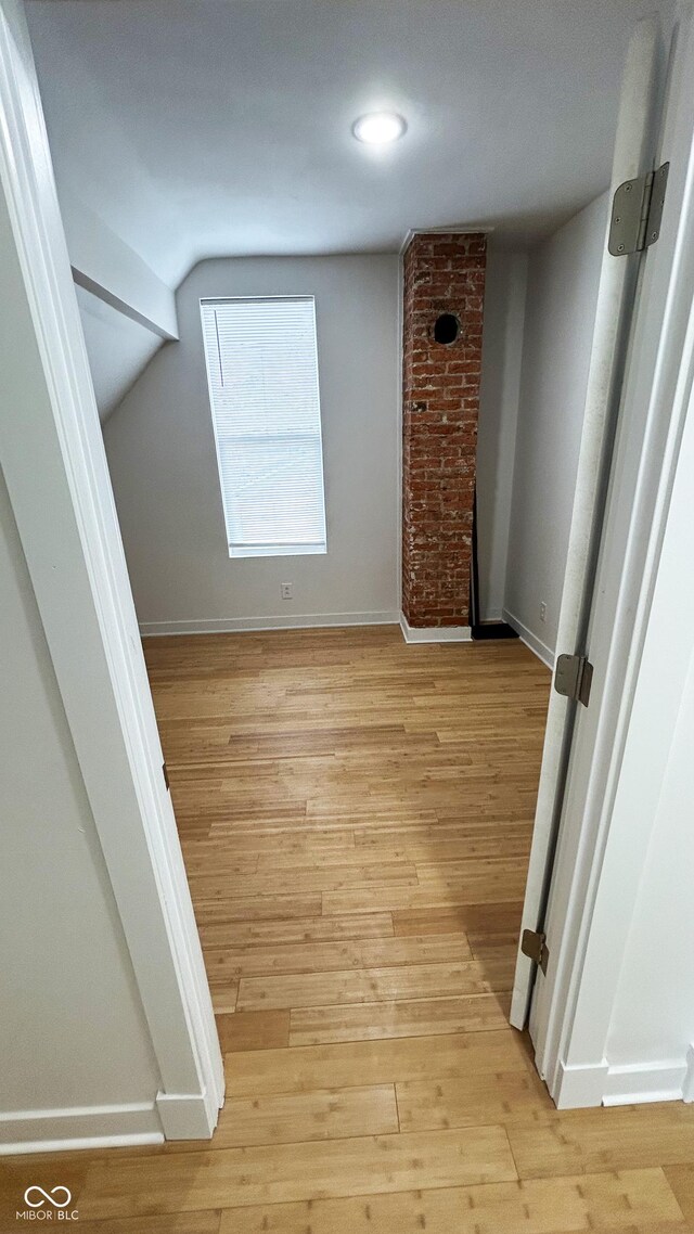 909 N Temple Ave, Indianapolis, IN 46201 - spare room with light wood-type flooring, baseboards, and lofted ceiling