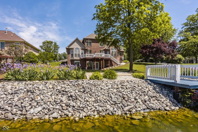 719 E New Rd, Greenfield, IN 46140 - back of house with a deck with water view, stairs, and a yard
