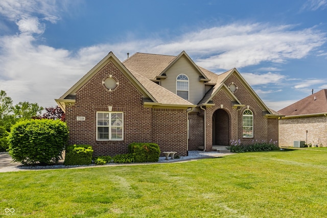 719 E New Rd, Greenfield, IN 46140 - traditional-style home with brick siding, a front yard, roof with shingles, and cooling unit