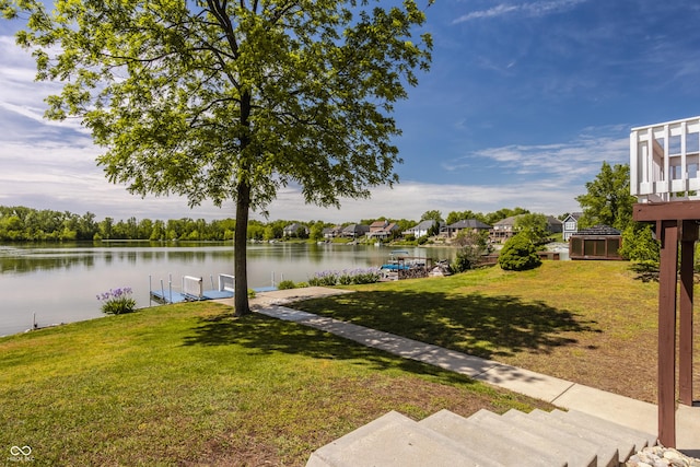 719 E New Rd, Greenfield, IN 46140 - view of grassy yard featuring a dock, a water view, and boat lift