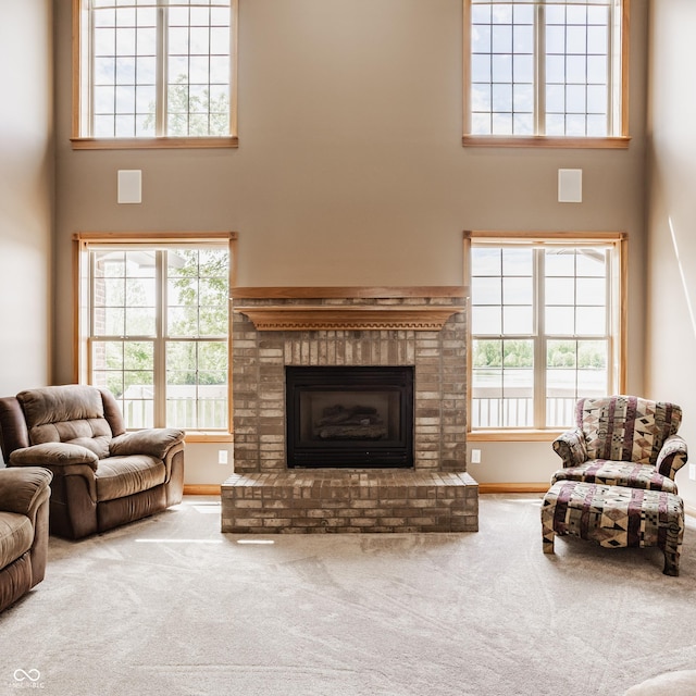 719 E New Rd, Greenfield, IN 46140 - living room with a towering ceiling, carpet floors, a fireplace, and baseboards