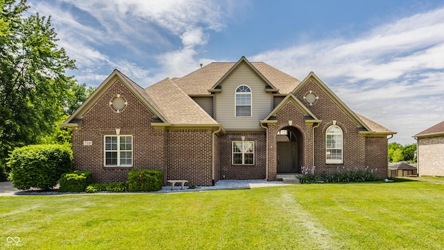 719 E New Rd, Greenfield, IN 46140 - view of front of home featuring brick siding, a front yard, and a shingled roof