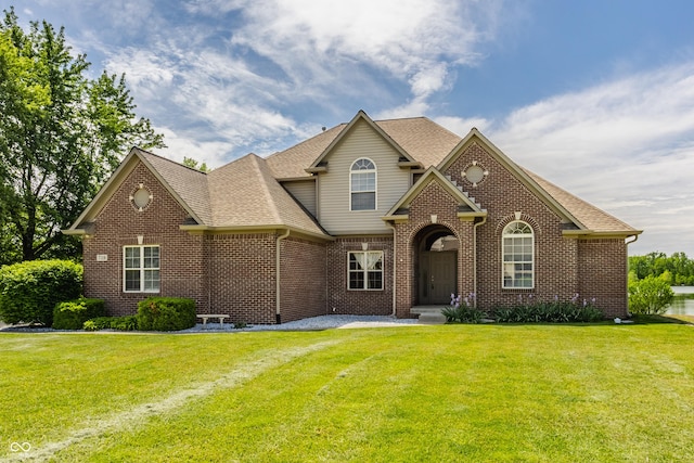 719 E New Rd, Greenfield, IN 46140 - traditional-style home with brick siding, a front yard, and roof with shingles