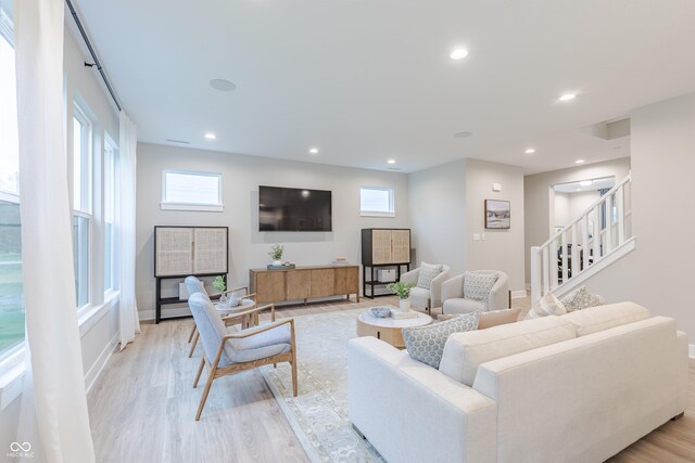 1085 Bevy Blvd, Danville, IN 46122 - living area featuring light wood-style flooring, plenty of natural light, stairway, baseboards, and recessed lighting