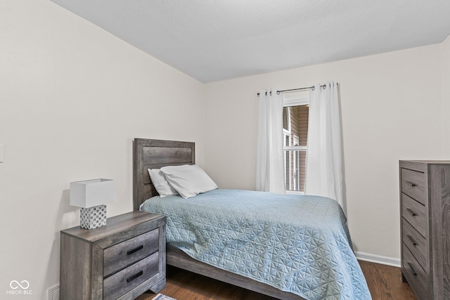 426 Tipton Ln, Columbus, IN 47201 - bedroom with dark wood-style flooring and baseboards