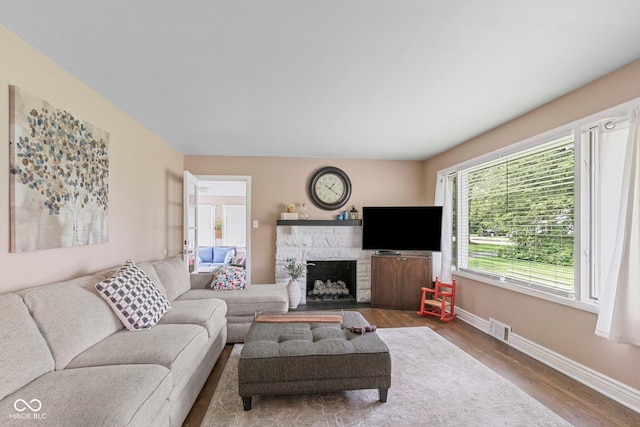 426 Tipton Ln, Columbus, IN 47201 - living area with wood finished floors, a fireplace, and baseboards