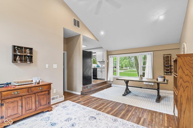 426 Tipton Ln, Columbus, IN 47201 - living room featuring wood finished floors, baseboards, a ceiling fan, high vaulted ceiling, and recessed lighting