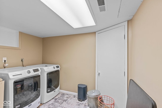 426 Tipton Ln, Columbus, IN 47201 - washroom featuring separate washer and dryer and baseboards