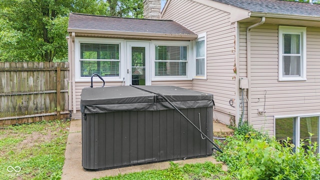 426 Tipton Ln, Columbus, IN 47201 - view of property exterior with a hot tub, a chimney, and roof with shingles