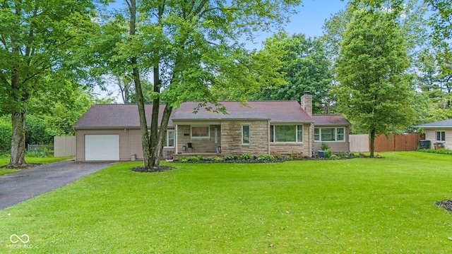 426 Tipton Ln, Columbus, IN 47201 - view of front of home with asphalt driveway, a garage, stone siding, a chimney, and a porch