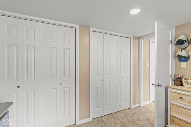 426 Tipton Ln, Columbus, IN 47201 - bedroom with two closets, light carpet, and baseboards