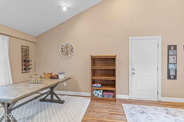 426 Tipton Ln, Columbus, IN 47201 - office featuring light wood-style flooring, baseboards, and high vaulted ceiling