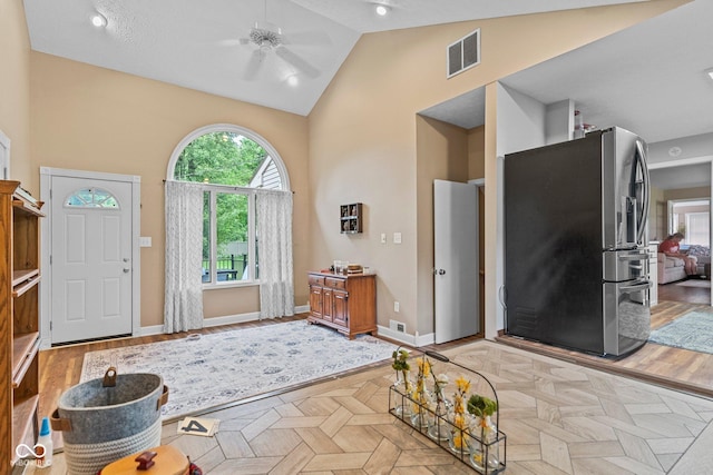 426 Tipton Ln, Columbus, IN 47201 - foyer featuring a ceiling fan, high vaulted ceiling, baseboards, and parquet flooring