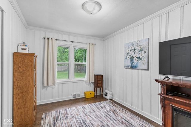 426 Tipton Ln, Columbus, IN 47201 - living area with wood finished floors, ornamental molding, baseboards, and a decorative wall