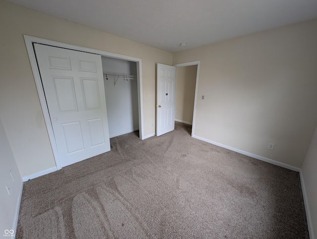 10722 Mistflower Way, Indianapolis, IN 46235 - unfurnished bedroom featuring carpet floors, a closet, and baseboards