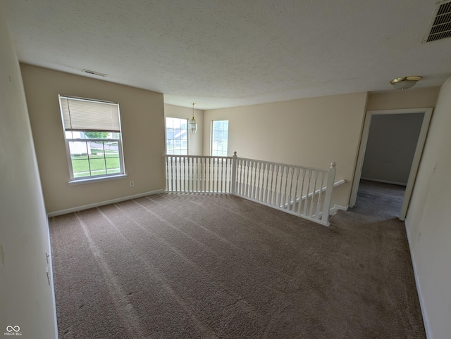 10722 Mistflower Way, Indianapolis, IN 46235 - unfurnished room featuring carpet floors, baseboards, a chandelier, and a textured ceiling